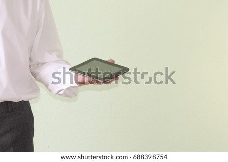 Business concept modern technology. A man is holding a black tablet in his hands. Photo for your design