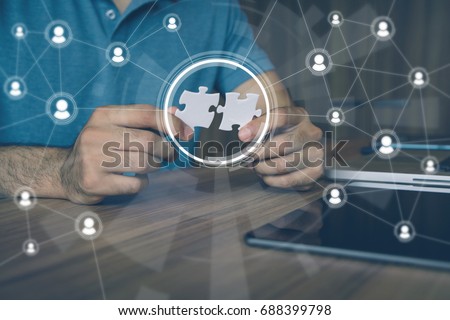 man holding pieces of jigsaw puzzle. business matching concept. crowd sourcing. freelancer. teleworking. Royalty-Free Stock Photo #688399798