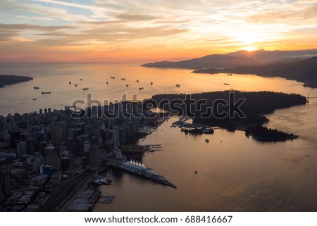 Beautiful aerial view of Downtown Vancouver City, British Columbia, Canada. Picture taken from an airplane during a cloudy summer sunset.