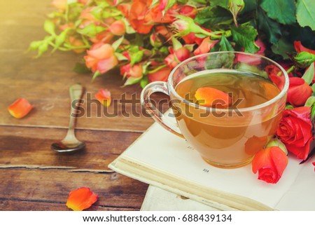 Book and tea. Flowers. Selective focus.