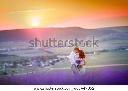 Beautiful young couple in love in a lavender field