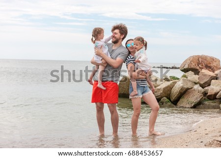 Family vacation parents and children on the sea shore summer day