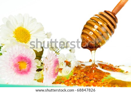 golden honey with pollen and flowers