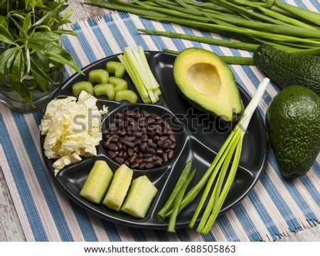 Green vegetables plate/stripes background