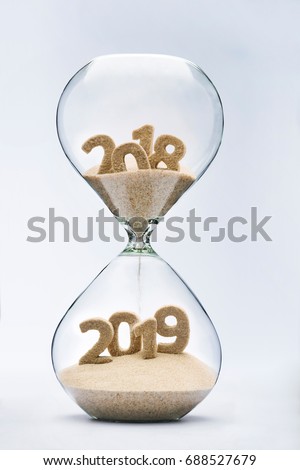 New Year 2019 concept with hourglass falling sand taking the shape of a 2019 Royalty-Free Stock Photo #688527679