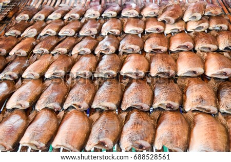 Trichogaster Dried fish on Bamboo floor. picture for add text. thai food concept