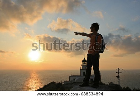 Mediterranean sunset at the Akrotiri Lighthouse in Santorini, Greece. Royalty-Free Stock Photo #688534894