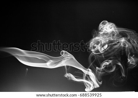 White smoke on black background.