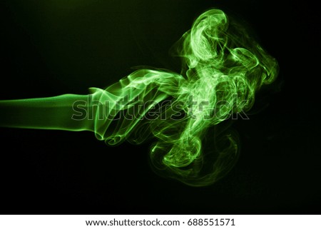 Green smoke on black background.