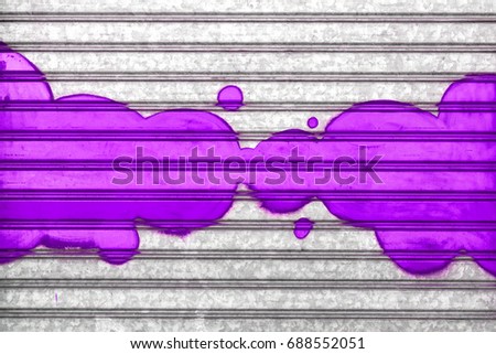 Purple bubbles painted with spray paint on a roller shutter.