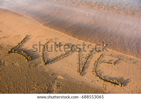 Love word written in sand. Summer beach concept