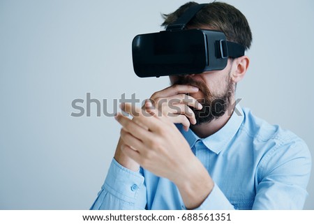 Man with a beard in 3d glasses virtual reality on a light background                               