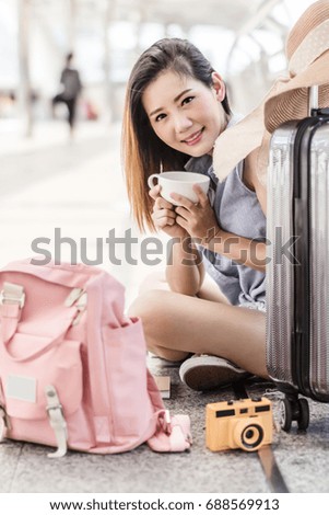 Blur happy smiling Asian young Japanese girl with luggage drinking coffee and enjoying view bangkok city. Fashion travel tourist woman relaxing and holding cup coffee in hand.