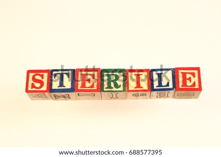 The term sterile visually displayed on a white background in landscape format using colorful wooden blocks