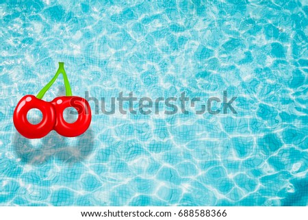 Chery pool float, ring floating in a refreshing blue swimming pool with 