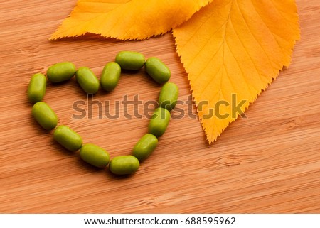 autumn bright yellow leaves on wooden surface, background