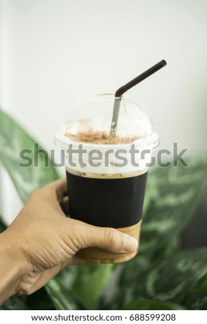 ice coffee in human hand 