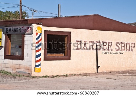 Barber shop on Route 66 with painted barber pole on side of building