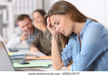 Side view portrait of a bullying victim being criticized at office Royalty-Free Stock Photo #688614079