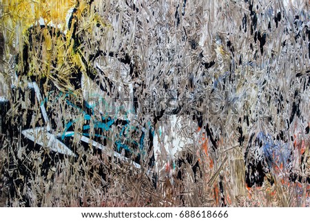 Grunge abstract background. Weathered graffiti paint leftovers on the plywood.