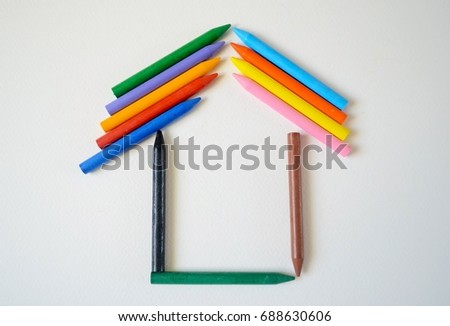 Color pencils, folded in the form of a house. House of pastel pencils. 