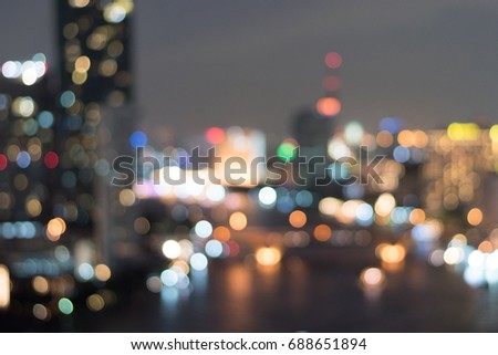 Blur abstract background of city night lights of cityscape nearby river.