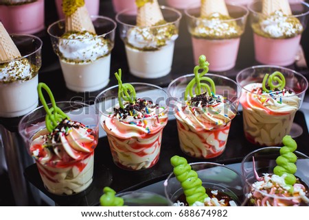 Closeup of sweet tasty dessert on modern table buffet. tiramisu dessert in glass.