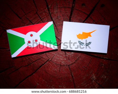 Burundi flag with Cypriot flag on a tree stump isolated