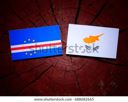 Cape Verde flag with Cypriot flag on a tree stump isolated