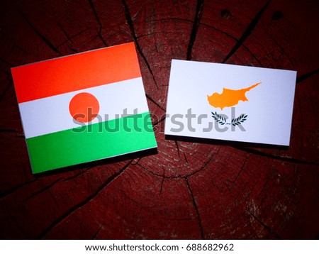 Niger flag with Cypriot flag on a tree stump isolated