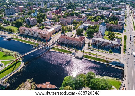 Aerial view over city Jelgava and bridge over Lielupe river during sunny summer day.