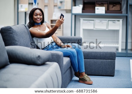 Portrait of a beautiful african american woman taking a selfie in the shop.