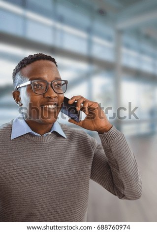 Digital composite of Happy business man talking on the phone against office background