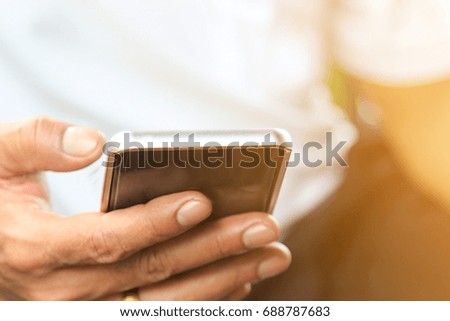Close up image of mobile device,a man using smartphone for work.