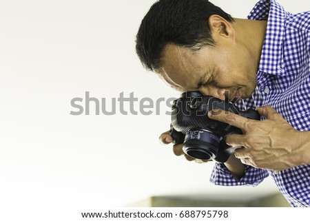 Commercial stock photographer during a photo shoot. Attractive, Young Mature Professional Photographer Business Man Serious While Taking a Picture.