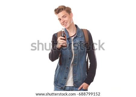Portrait of handsome college boy holding glass bottle of cola