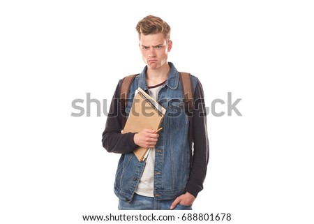 Portrait of schoolboy posing with notepads against white background