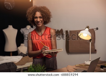 A young fashion designer working on her atelier