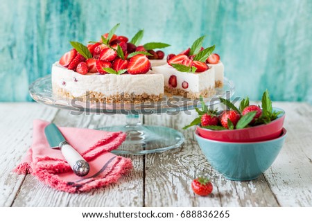 Sliced No Bake Strawberry Cheesecake Decorated with Fresh Berries and Mint Royalty-Free Stock Photo #688836265