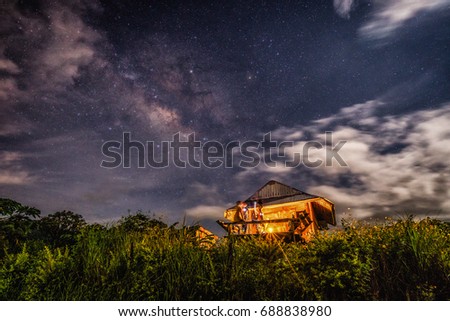 The hut at the rice field with beautiful milky way 
