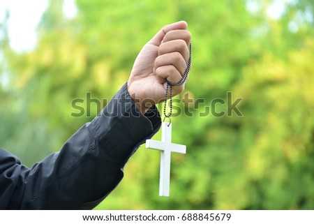 Christian cross banner,Cross in Human Hand Blurred nature background