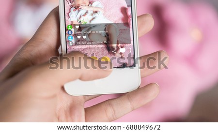 Mother using smartphone record video of her baby live chat to her Friend. Streaming Video is a most popular in social networks