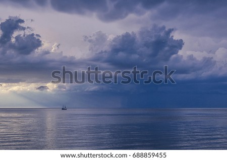 ROMANTIC EVENING - Storm clouds over the sea and a walking ship