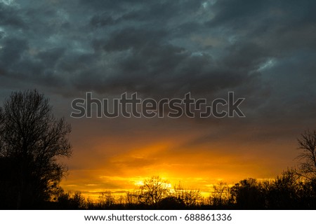 Storm clouds and sunset in the countryside, spring