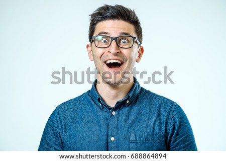 Man with shocked, amazed expression isolated on gray background Royalty-Free Stock Photo #688864894