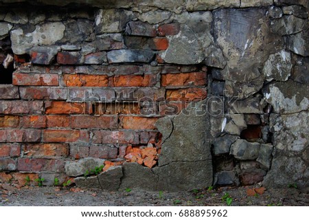 Ancient damaged brick wall of old basement. Gothic grunge background. Ruins cracked building
