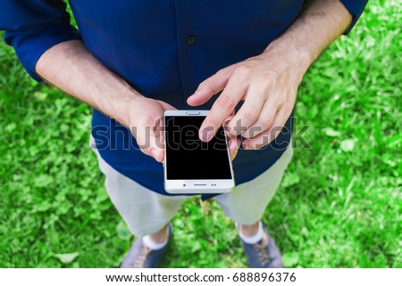 man, using a smart phone, in the hands, background, with copy space, for advertising