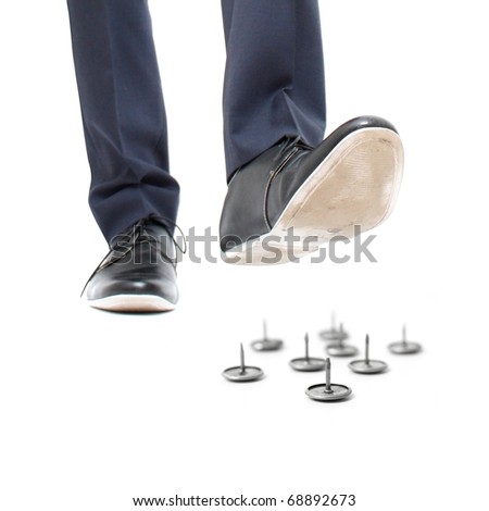 A businessman about to step on needles