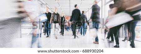 crowds of people walking in a shopping mall
