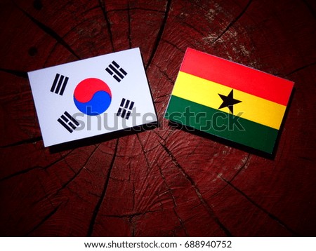 Ghanaian flag with South Korean flag on a tree stump isolated